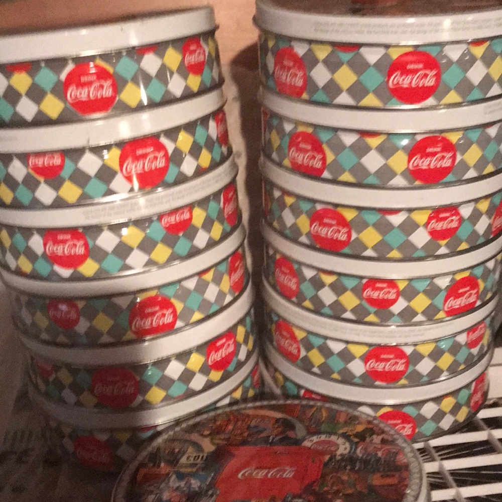 12 Coca Cola tins, 21” round, 2” depth, 6.5” wide